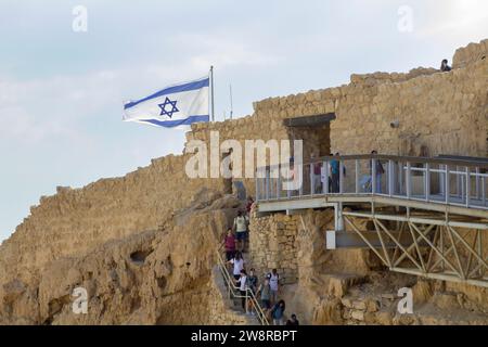 November 2022, The israeli flag flies proudly as tourists visit Massada, built by Herod the Great, and the ancient site of Jewish revolt against the R Stock Photo