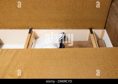 Storage space inside the sofa where the pillows are at home in the apartment, bedroom furniture close-up Stock Photo