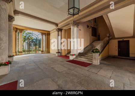 Cuneo, Piedmont, Italy - December 19, 2023: The atrium with the grand staircase of Cuneo Prefecture building (1882) on Via Roma, a majestic neoclassic Stock Photo