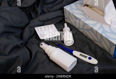 Close up of come home medicine for flues on a blanket at home Stock Photo