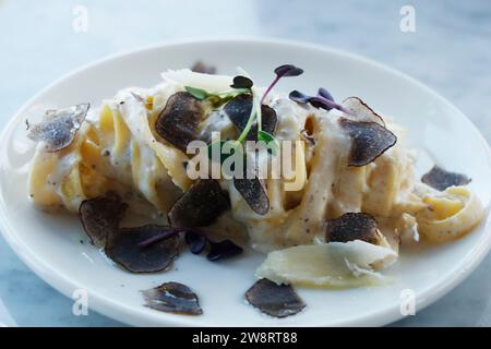 italian food pasta dish tagliatelle truffle sauce in close up on a dining table Stock Photo