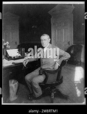 Woodrow Wilson, full-length portrait, seated at desk, facing slightly left Stock Photo