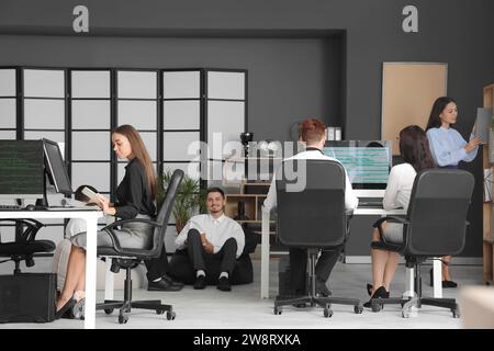 Team of young programmers working in office Stock Photo