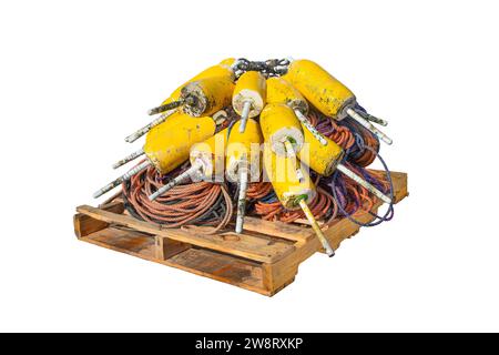 Floats for Lobster Traps:  Marker buoys and ropes for attaching them to lobster traps lie neatly stacked on a wooden pallet. Stock Photo