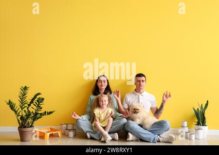 Happy family meditating during repair of their new house Stock Photo