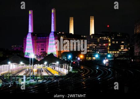 London, UK. 16th December, 2023. An illuminated Battersea Power Station at night as viewed from near Victoria Station. Two special services - a steam train and luxury dining excursions operated from London's Victoria Station in the run up to Christmas, where they passed Battersea Power Station, lit up dusk onwards in a festive design by artist David Hockney. Credit: Eleventh Hour Photography/Alamy Live News Stock Photo