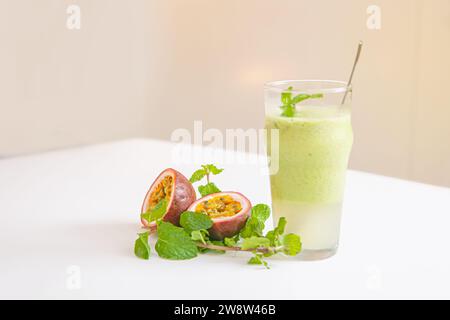 Vegetarian passion fruit and mint leaves smoothie in glass isolated on white background Stock Photo