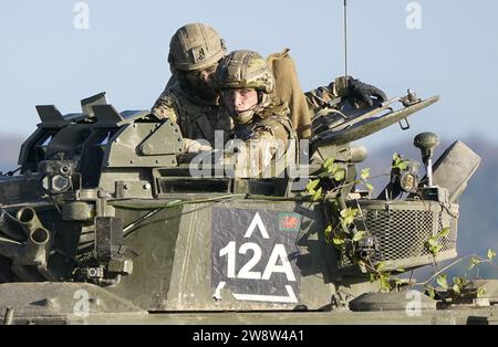 PA REVIEW OF THE YEAR 2023 File photo dated 23/11/23 - The Prince of Wales, Colonel-in-Chief, 1st Battalion Mercian Regiment (right) rides in a Warrior Armoured Fighting Vehicle as he takes part in an attack exercise during a visit to the regiment, in the south west of the UK, for the first time following his appointment to the role by King Charles III. Issue date: Thursday December 21, 2023. Stock Photo