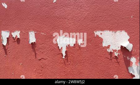 Paint peeling from the red wall Stock Photo