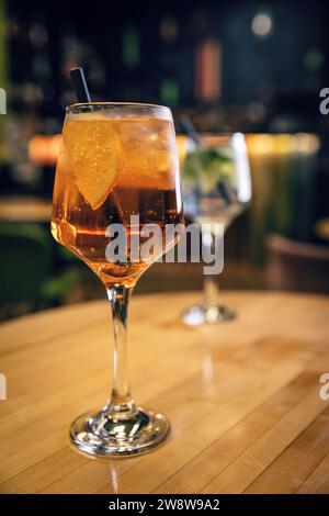 Aperol spritz cocktail in big wine glass with orange slices, summer Italian fresh alcohol cold drink Stock Photo