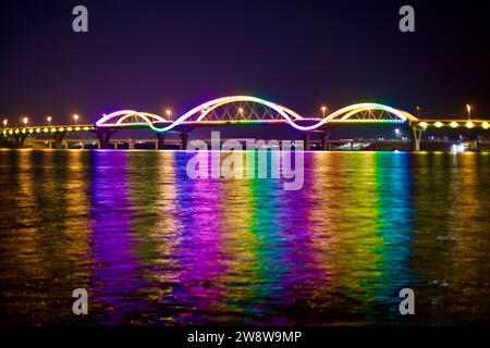 Over the South Han River, South Korea - February 20, 2020: The Tangeum Grand Bridge radiates with a dazzling display of rainbow colors, reflecting off Stock Photo