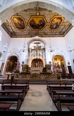 Altar, prayer benches and ceiling paintings inside the Church of Saint Mary of the Assumption, Chiesa Matrice di Santa Maria Assunta. Stock Photo