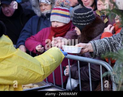 Krakow, Poland - Dec 17, 2023: Christmas Eve for poor and homeless on the Main Square in Cracow. The group Kosciuszko prepares the greatest eve in the Stock Photo