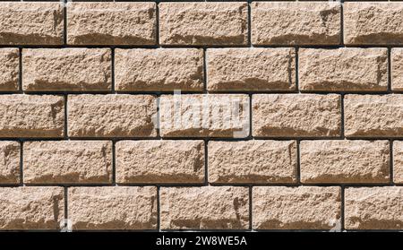 Masonry made of designer processed stone with deep seams. Background Stock Photo