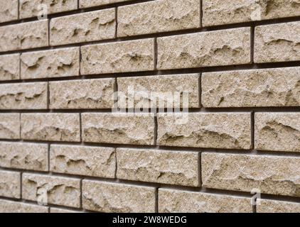 Angled view of the textured surface of clinker brickwork with deep seams. Background Stock Photo