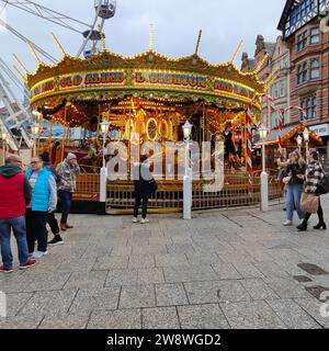 Nottingham,United Kingdom,15th December 2023:Picture of merry go round and people at Nottingham Christmas market. Stock Photo