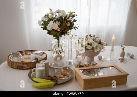 Flowers, tea box and decoration on a table Stock Photo