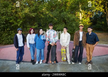 a group of young people with skateboards stands in a skate park Stock Photo