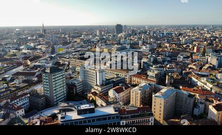 Aerial drone view of Milano city center and skyline in Lombardy, Italy. Historic urban architecture featuring modern skyscrapers and red rooftops. Stock Photo