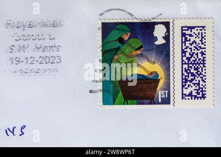 1st class Christmas stamp stuck on envelope - stamp barcoded, stamp barcode UK Stock Photo