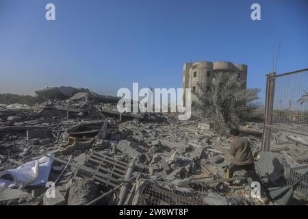 Rafah, Palestinian Territories. 22nd Dec, 2023. A Palestinian inspects debris of destroyed buildings following Israeli bombardment. Credit: Mohammed Talatene/dpa/Alamy Live News Stock Photo