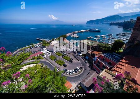 Aerial view of the ferry harbour of Sorrento, Marina piccola and the Bay of Naples with the smoking volcano Vesuvius in the distance. Stock Photo