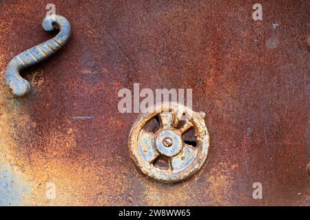 A metal rusty old door of an oven with handles in a close up view Stock Photo