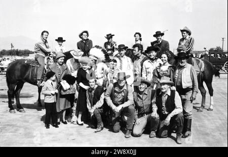 CLINT EASTWOOD in group photo circa 1963 candid at the time he was appearing in the TV series RAWHIDE at a cowboy / western show for disabled children with CLU GULAGER on horse at far left Stock Photo