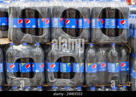 Packaging of plastic Pepsi Co bottles in film on pallets for sale in retail and wholesale stores. Thailand, Bangkok 13 december 2023. Stock Photo