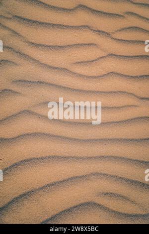Rippled Sand Patterns with Contrasting Shadows in Warm Sunlight Stock Photo