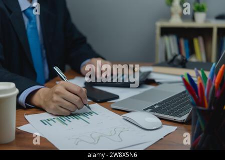 Businessman using calculator and laptop for accounting finance on desk. business report financial, tax, investments, statistics and analytic research Stock Photo
