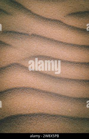 Rippled Sand Patterns with Contrasting Shadows in Warm Sunlight Stock Photo