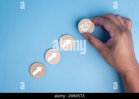 startup leadership, planning for business strategy innovation performance target solution project marketing achievement. man holding wood rocketship a Stock Photo