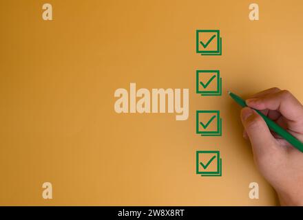 Businessman checking mark on the check boxes with marker green. Tick Checklist form feedback, satisfaction, exam on background concept. Stock Photo