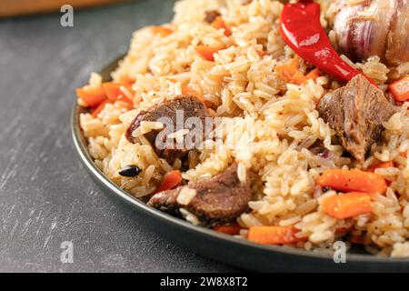 Large dish with Uzbek festive pilaf plov Stock Photo