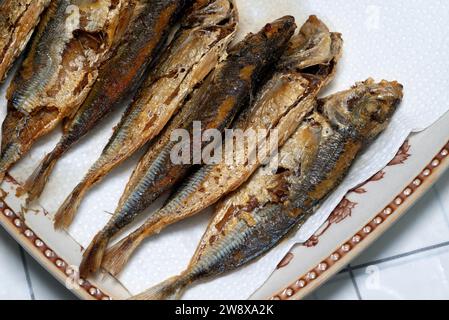 Fried horse mackerel or Japanese jack mackerel on a plate with paper towel Stock Photo