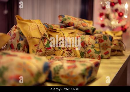 Small Christmas present in between bigger presents Stock Photo