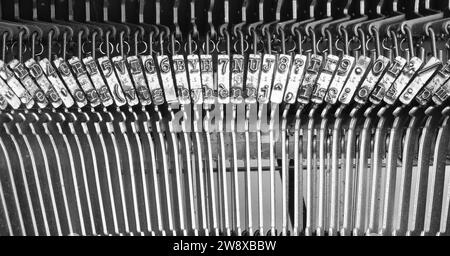 iron hammers of the antique typewriter ideal as a backdrop for book presentations Stock Photo