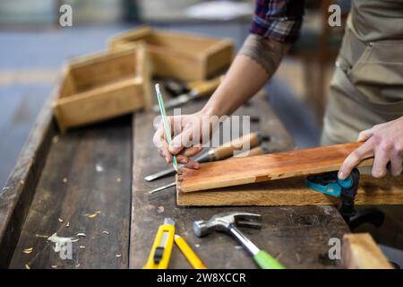 Female carpenter working in her workshop, close-up Stock Photo