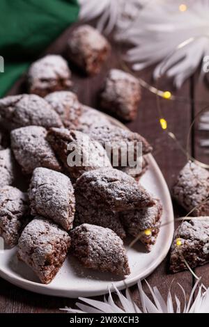 Italian Christmas cookies Castagnelle with almonds, cocoa and egg whites on a wooden background. Gluten free cookies. Stock Photo