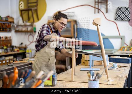 Female carpenter working in her workshop Stock Photo