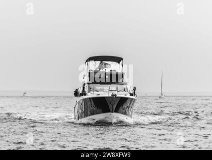 an expensive motor yacht head on underway in the hamptons Stock Photo