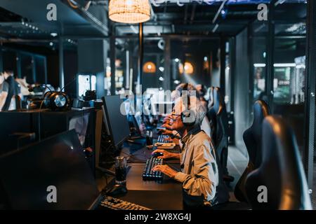 Senior man playing computer game in gaming lounge during weekend Stock Photo