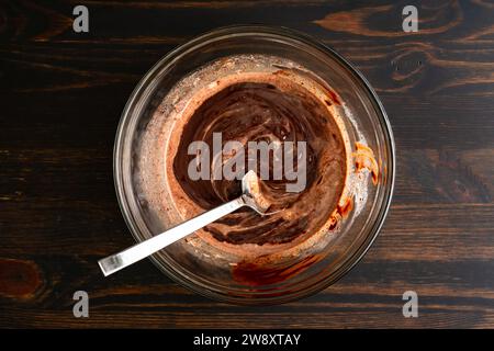 Making Chocolate Ganache in a Glass Mixing Bowl: Chopped semi-sweet chocolate mixed with heated heavy cream Stock Photo