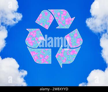 The universal recycling symbol. It is an internationally recognized symbol for recycling. Against blue sky. Stock Photo