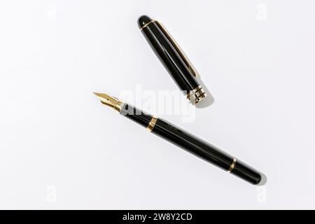 Fountain writing pen on white paper background. Copy space Stock Photo