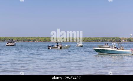 Shelter island, police boat cruising around anchored boats off crescent beach Stock Photo