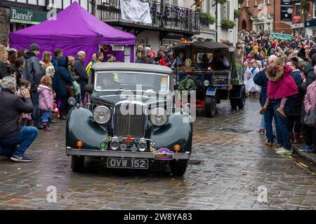 Lymm Dickensian Day 2023. People dressed in Dickensian costume; stalls in the streets; street entertainment; Grand Parade. Alvis car joins the parade Stock Photo