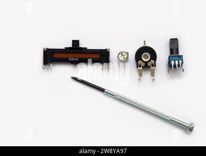 Rotating contact and sliding and trimmer (trimpot) potentiometers. Adjustable resistor or rheostat. Focused on trimmer pots. Stock Photo