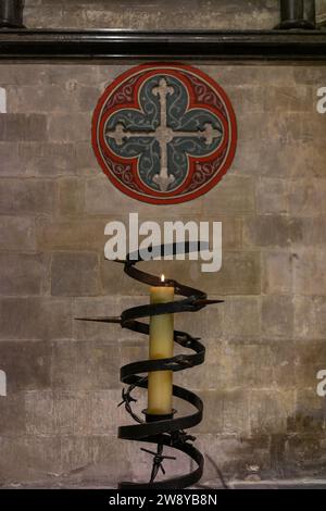 The prisoner of conscience candle (Amnesty International) burning inside Salisbury Cathedral at the Trinity Chapel, Salisbury, Wiltshire, England, UK Stock Photo